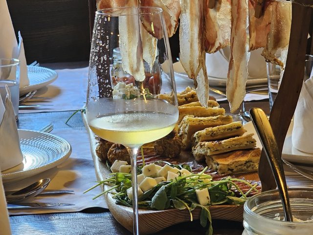 A tasting board of local pršut, cheese and wine.